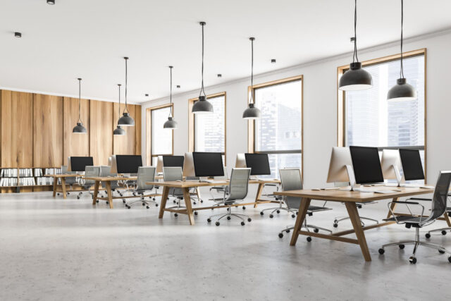 interior-open-space-office-with-white-light-wooden-walls-loft-windows-concrete-floor-rows-light-wooden-computer-tables-3d-rendering